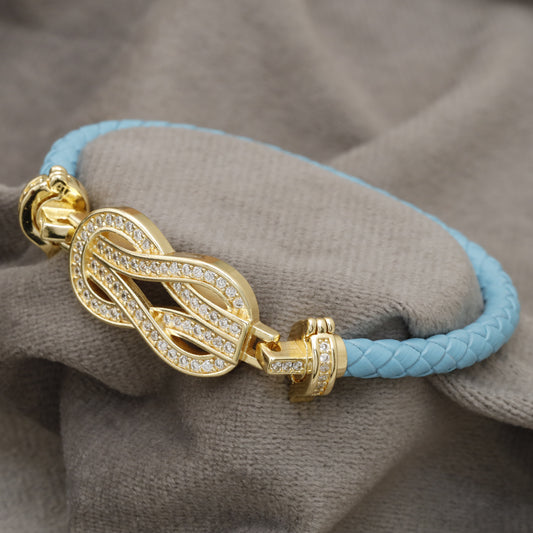 Light Blue Braided Leather Bracelet Gold Crystal Infinity Knot Clasp KAR85 – إسوارة جلد أزرق فاتح عقدة