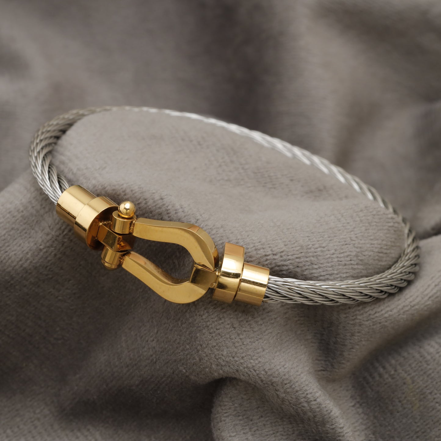 Silver Steel Cable Bracelet with Gold Horseshoe Clasp B56